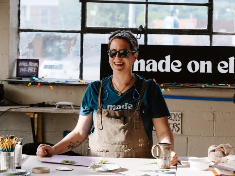 Ashlee standing at her desk in the Made on Elk pottery studio.