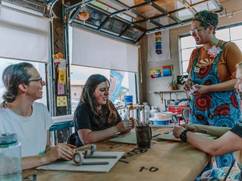 Ashlee Springer hosting people making pottery at an event.