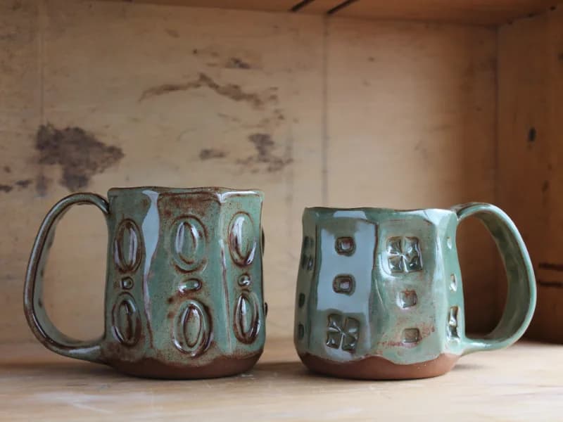 Handmade Ashlee Springer pottery mugs, two green stamped mug examples.